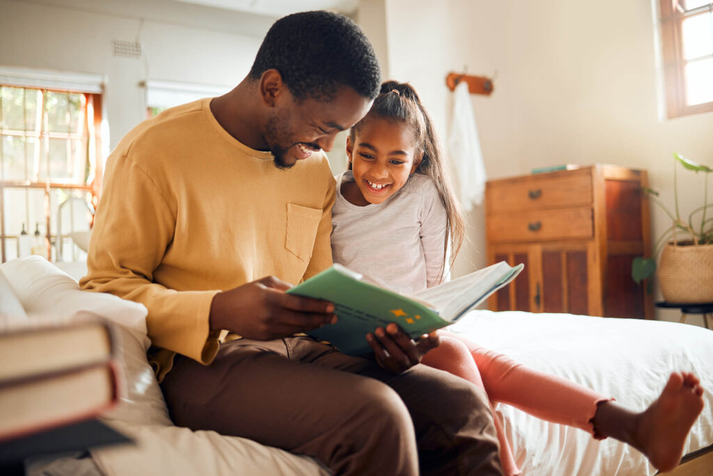 father and daughter using their eyes to read