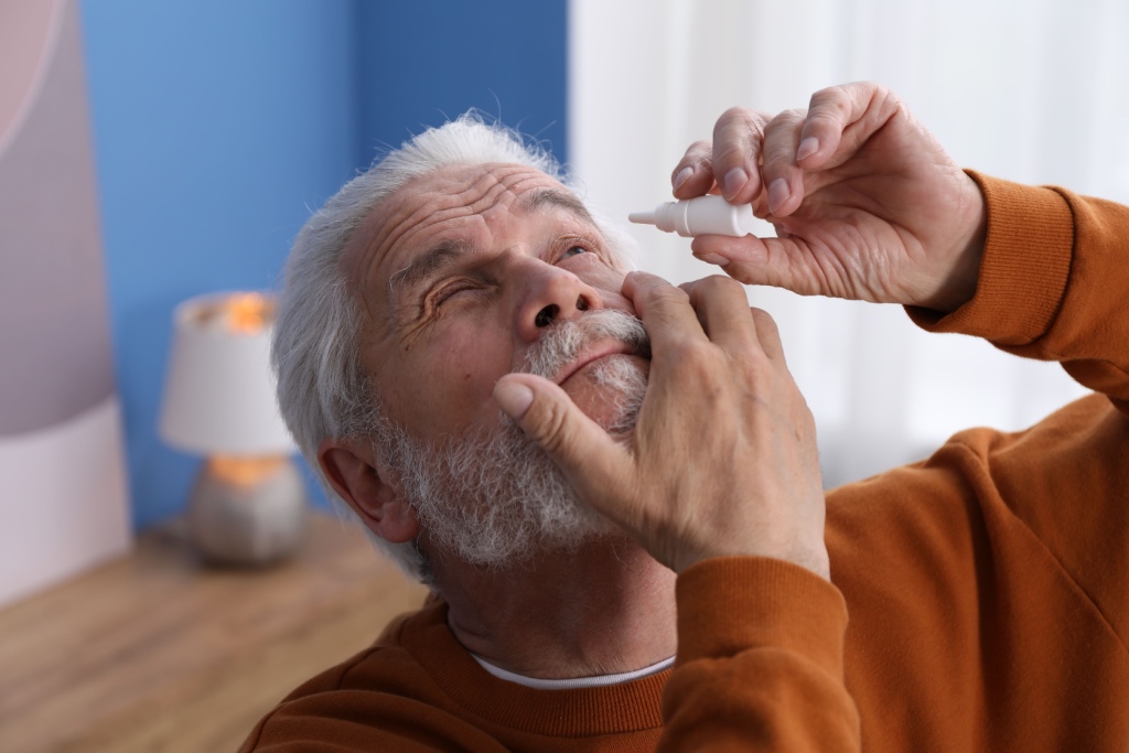 man adding eyedrops to care for cataracts