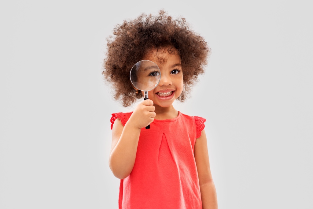 child with magnifying glass