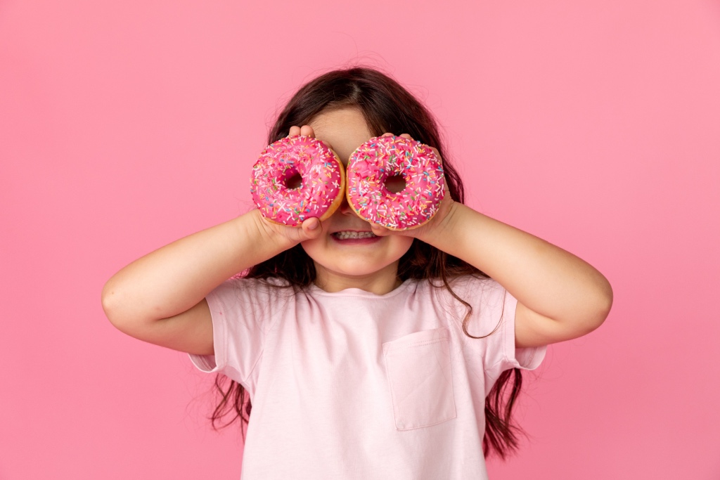 happy child with donuts for eyes