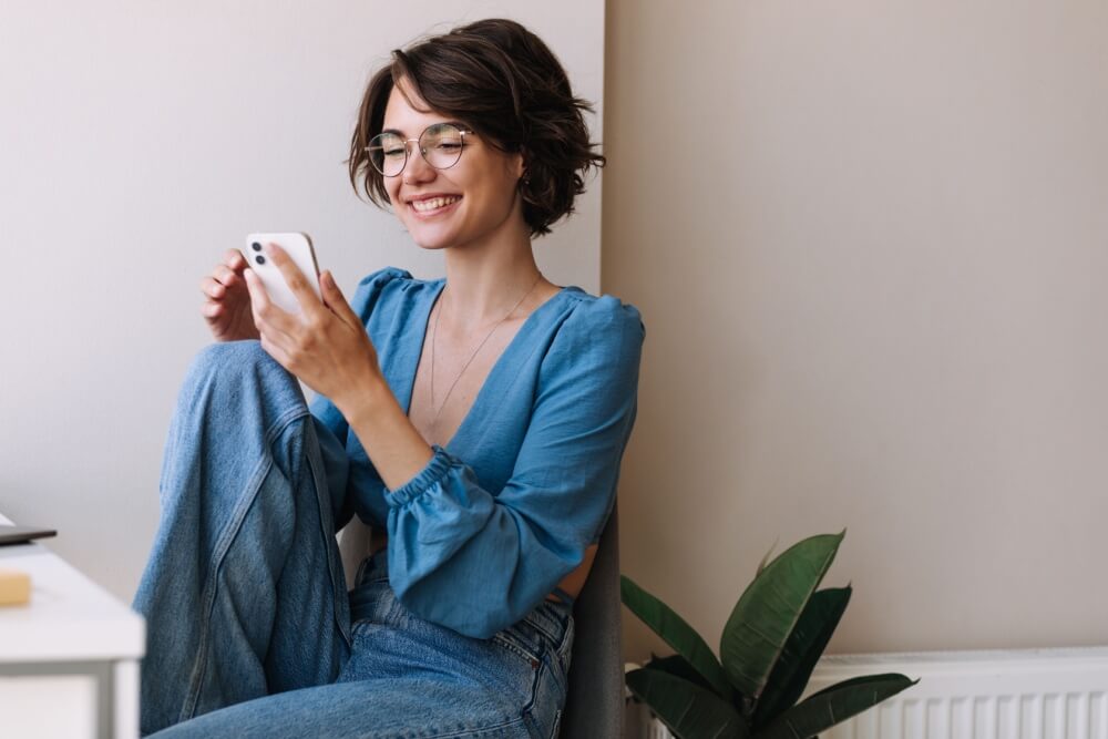 happy person browsing phone